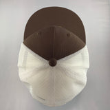 Brown and white cap on a gray background