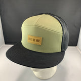 Loden and black cap with a "Let's Be Irie" patch on a black background