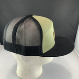 Trucker hat with black mesh back and green front on a mannequin head against a gray background