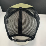 Black mesh cap on a white surface with a dark background