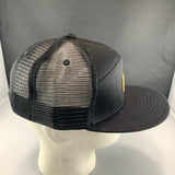 Black mesh cap on a mannequin head against a gray background