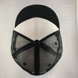 Black and white cap with mesh back on a light gray background
