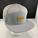 Gray cap with a beige 'Let's Be Irie" patch on a black background