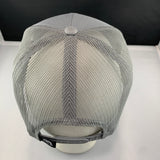 Gray mesh cap on a white surface with a black background