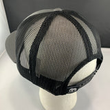 Black mesh cap on a mannequin head with a plain background