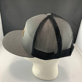 Gray and black mesh cap on a mannequin head against a gray background