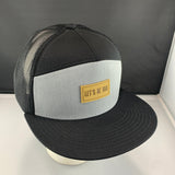 Black and gray cap with a 'Let's Be Irie' patch on a black background
