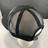 Black mesh cap on a mannequin head with a gray background