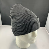 Gray knit beanie on a mannequin head against a dark background