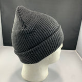 Gray knit beanie on a mannequin head against a gray background