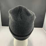 Dark gray knit beanie on a mannequin head against a plain background