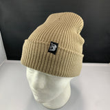 Beige knit beanie with a Let's Be Irie logo woven tag on a mannequin head against a black background