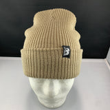 Beige knit beanie with a Let's Be Irie logo woven tag on a mannequin head against a black background