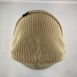 Knitted beige beanie on a light gray background