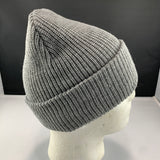 Gray knit beanie on a mannequin head against a black background