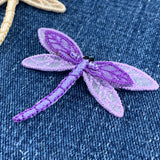 Purple dragonfly patch on denim fabric