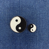 2 yin yang patches on a denim background