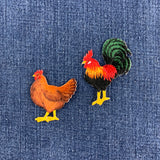 two patches of a rooster and a hen on a denim background