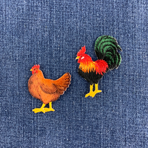 two patches of a rooster and a hen on a denim background