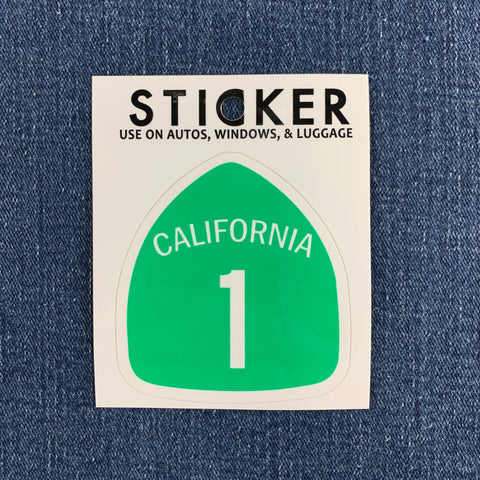California highway 1 sticker displayed on a denim background