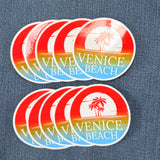 Set of ten Venice Beach stickers with a palm tree design on a denim background