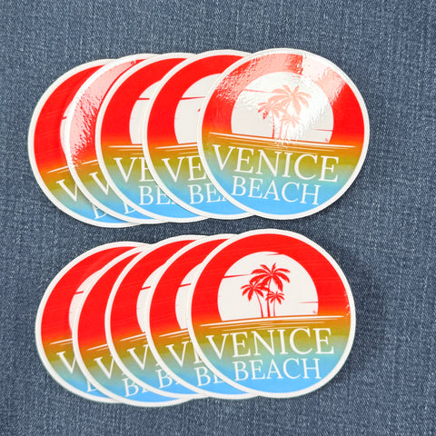 Set of ten Venice Beach stickers with a palm tree design on a denim background