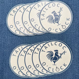 Set of ten Tailcock O'Clock stickers on a denim background featuring a rooster with a martini in hand.