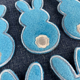 fuzzy blue bunny patches on a denim background
