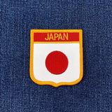 Embroidered patch with 'Japan' text on a blue fabric background