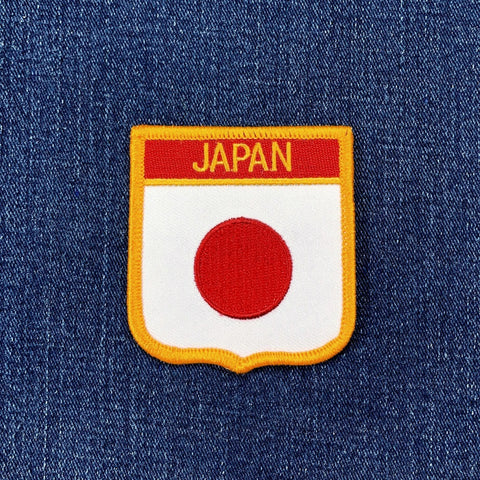 Embroidered patch with 'Japan' text on a blue fabric background