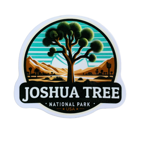 A vinyl decal featuring a stylized representation of Joshua Tree National Park with a tree and a sunset in the background, and the text 'JOSHUA TREE NATIONAL PARK' along with 'USA'.