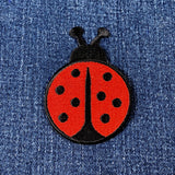 Red ladybug patch on a denim background