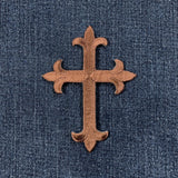 Brown cross patch on blue denim fabric