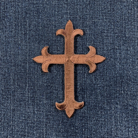 Brown cross patch on blue denim fabric