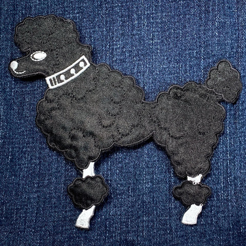 Black poodle patch on a denim background