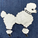 Embroidered poodle patch on denim fabric