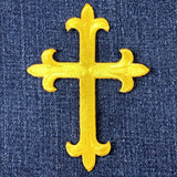 Yellow cross patch on denim fabric