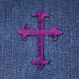 Purple cross patch on denim fabric
