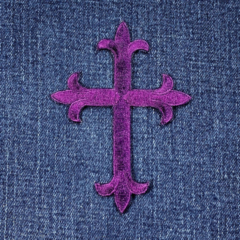 Purple cross patch on denim fabric