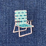 Embroidered lawn chair patch on denim fabric