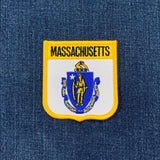 Massachusetts state emblem patch on a blue denim background