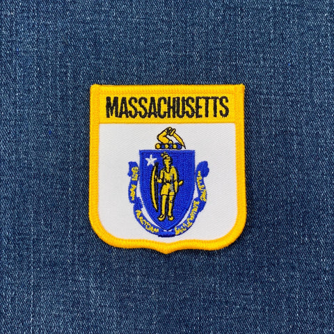 Massachusetts state emblem patch on a blue denim background