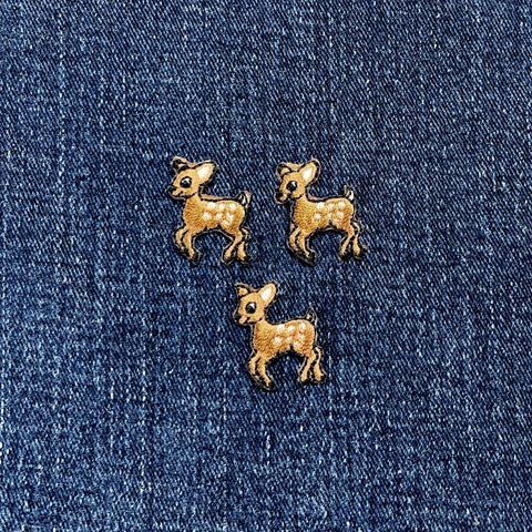 three miniature deer patches on a denim background