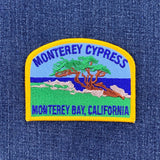 Embroidered patch of Monterey Cypress on a denim background