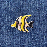 Fish-shaped patch on denim fabric