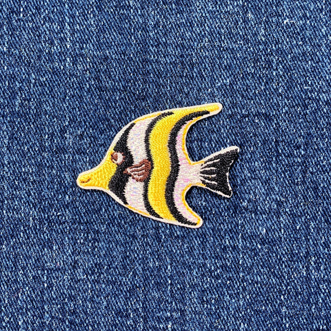 Fish-shaped patch on denim fabric