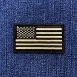 OD olive green and black American flag patch on a denim background