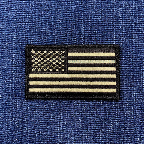 olive drab American flag patch on a blue denim background
