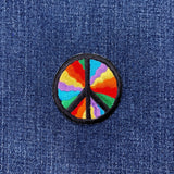 Colorful peace symbol patch on a denim background