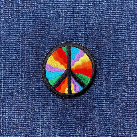 Colorful peace symbol patch on a denim background